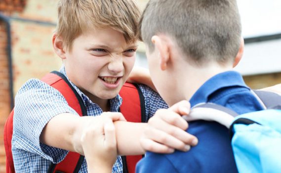 a boy being bullied by another boy