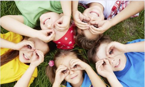 group of children using their hands for binoculars